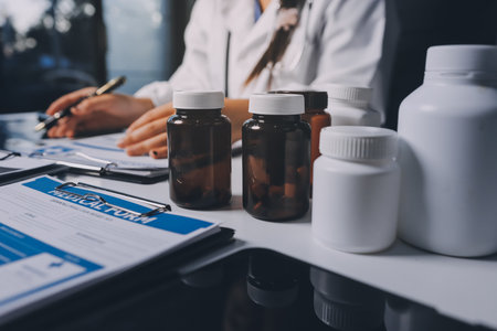 Group of doctors attending seminar in hospital lecture hall with senior physician giving medical presentation and professional training session on healthcare practicesの写真素材