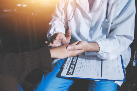 A female nurse caregiver holds hands to encourage and comfort an elderly woman. For care and trust in nursing homes for people of retirement age Caregiver helping elderly woman provides medical adviceの写真素材