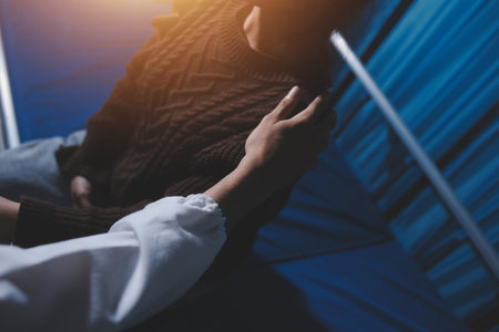 A female nurse caregiver holds hands to encourage and comfort an elderly woman. For care and trust in nursing homes for people of retirement age Caregiver helping elderly woman provides medical adviceの写真素材