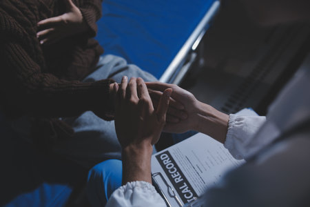 A female nurse caregiver holds hands to encourage and comfort an elderly woman. For care and trust in nursing homes for people of retirement age Caregiver helping elderly woman provides medical adviceの写真素材