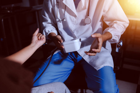 The doctor measures blood pressure to the patientの写真素材