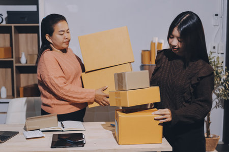 Asian woman selling clothes on camera live broadcast on social network at home. Online selling clothes on social media. Blogger woman influencer, SME retail store owner.の写真素材