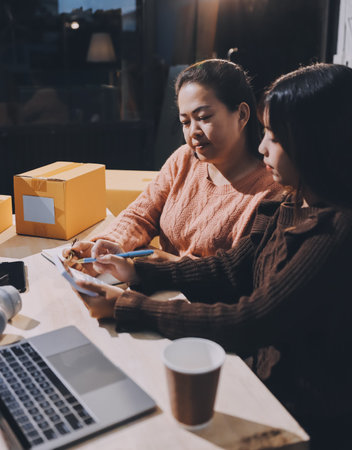 Asian woman describe selling clothes on camera live broadcast on social network at home, Online selling clothes on social media. Blogger woman influencer, SME retail store owner.の写真素材