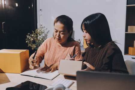 Asian woman selling clothes on camera live broadcast on social network at home, Online selling clothes on social media. Blogger woman influencer, SME retail store owner.の写真素材