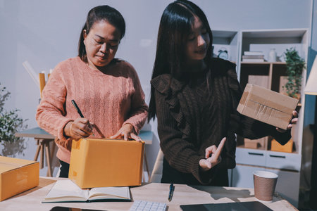 Asian woman describe selling clothes on camera live broadcast on social network at home, Online selling clothes on social media. Blogger woman influencer, SME retail store owner.の写真素材