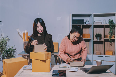 Asian woman selling clothes on camera live broadcast on social network at home, Online selling clothes on social media. Blogger woman influencer, SME retail store owner.の写真素材