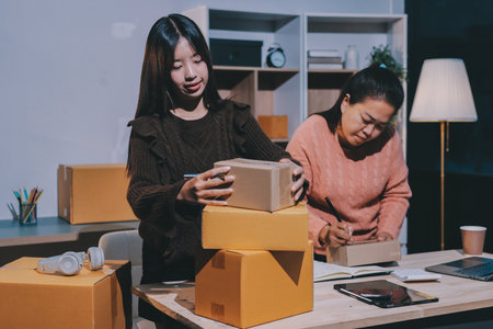 Asian woman selling clothes on camera live broadcast on social network at home. Online selling clothes on social media. Blogger woman influencer, SME retail store owner.の写真素材