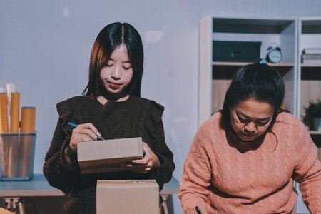 Asian woman selling clothes on camera live broadcast on social network at home, Online selling clothes on social media. Blogger woman influencer, SME retail store owner.の写真素材