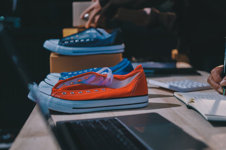 Asian woman selling clothes on camera live broadcast on social network at home, Online selling clothes on social media. Blogger woman influencer, retail store owner.の写真素材