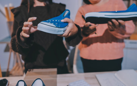 Asian woman describe selling clothes on camera live broadcast on social network at home, Online selling clothes on social media. Blogger woman influencer, SME retail store owner.の写真素材