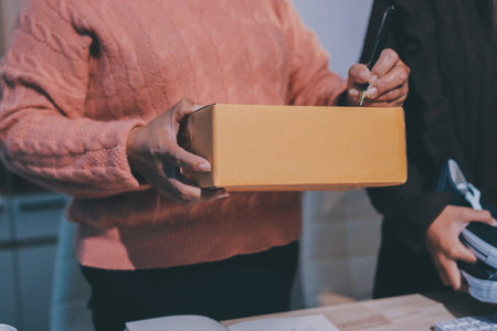 Asian woman selling clothes on camera live broadcast on social network at home, Online selling clothes on social media. Blogger woman influencer, SME retail store owner.の写真素材