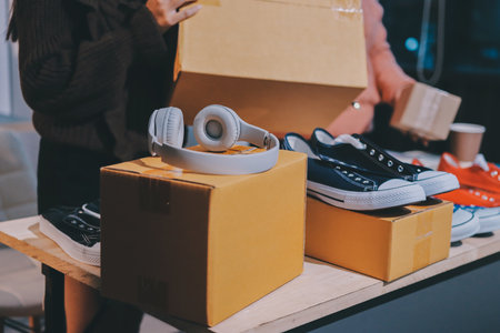 Asian woman selling clothes on camera live broadcast on social network at home, Online selling clothes on social media. Blogger woman influencer, SME retail store owner.の写真素材