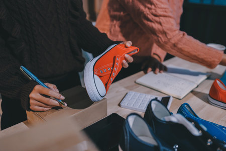 Asian woman selling clothes on camera live broadcast on social network at home, Online selling clothes on social media. Blogger woman influencer, SME retail store owner.の写真素材