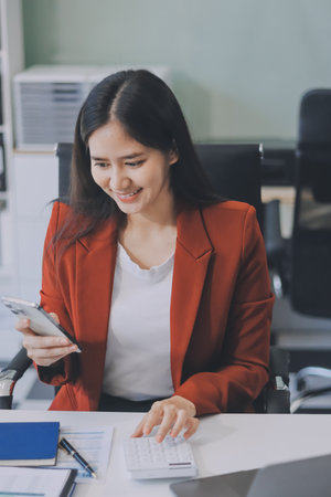 Asian business woman working on a laptop in a professional office