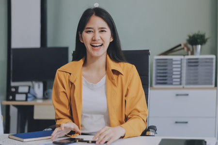 Business woman using calculator for do math finance on wooden desk in office and business working...