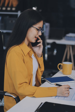 Business woman using calculator for do math finance on wooden desk in office and business working background, tax, accounting, statistics and analytic research concept.の写真素材