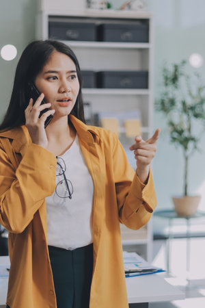 Business woman using calculator for math finance on wooden desk in office and business working background, tax, accounting, statistics and analytic research concept.の写真素材