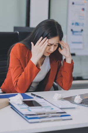 tired business woman sleepy and bored from sitting at a desk for a long time and has office syndromeの写真素材