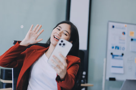 Serious charming woman using smartphoneの写真素材