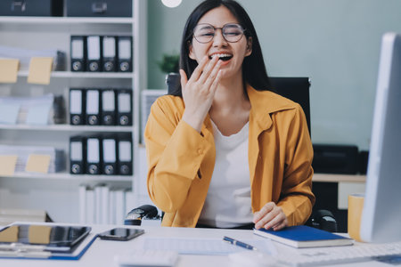 Business woman using calculator for do math finance on wooden desk in office and business working background, tax, accounting, statistics and analytic research concept.の写真素材
