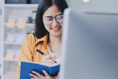 Business woman using calculator for math finance on wooden desk in office and business working background, tax, accounting, statistics and analytic research concept.の写真素材