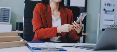 Asian business woman working on a laptop in a professional officeの写真素材