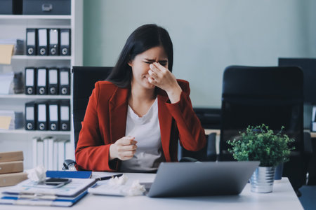 tired business woman sleepy and bored from sitting at a desk for a long time and has office syndromeの写真素材