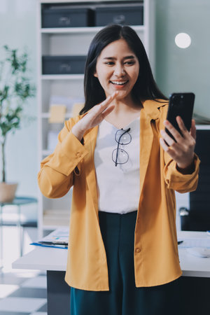 Business woman using calculator on wooden desk in office, tax, accounting, statistics and analytic research concept.の写真素材