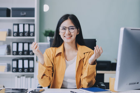Business woman using calculator for math finance on wooden desk in office and working background, accounting, statistics and analytic research concept.の写真素材