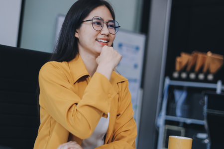 Business woman using calculator for do math finance on wooden desk in office and business working background, tax, accounting, statistics and analytic research concept.の写真素材