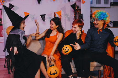 Joyful Halloween party with coworkers in costumes, celebrating with drinks and laughter, fostering teamwork and festive spiritの写真素材