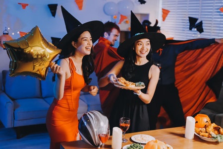 Joyful office Halloween party with coworkers in costumes, celebrating with drinks and laughter, fostering teamwork and festive spiritの写真素材