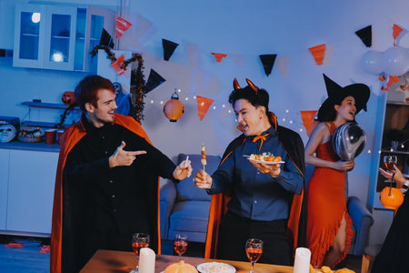 Joyful Halloween party with coworkers in costumes, celebrating with drinks and laughter, fostering...