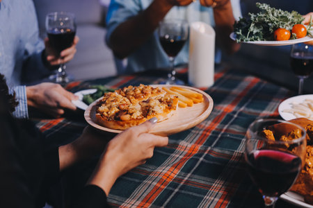 Diversity, dinner and group of people toast celebration together at party. Friends, happy and celebrate with food, wine and friendship for love, support and cheers champagne at business functionの写真素材