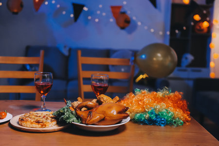 Joyful Halloween party with friends in costumes, celebrating with drinks and laughter, fostering teamwork and festive spiritの写真素材