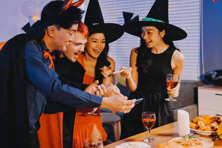 Joyful office Halloween party with coworkers in costumes, celebrating with drinks and laughter, fostering teamwork and festive spiritの写真素材
