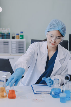 Portrait, science and happy woman on laptop in lab to research chemistry, test or innovation....