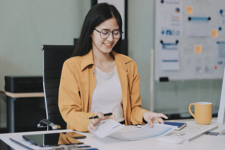 Business woman using calculator for math finance on wooden desk in office and working background.の写真素材