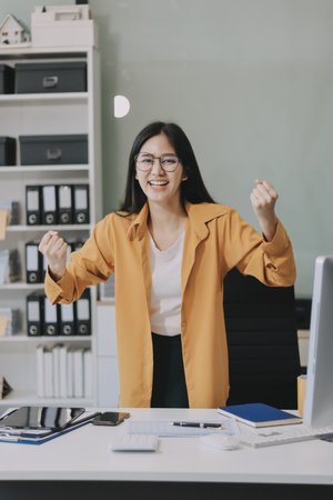 Business woman using calculator for math finance on wooden desk in office and business working background, tax, accounting, statistics and analytic research concept.の写真素材