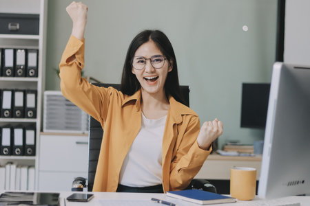 Business woman using calculator for do math finance on wooden desk in office and business working background, tax, accounting, statistics and analytic research concept.の写真素材