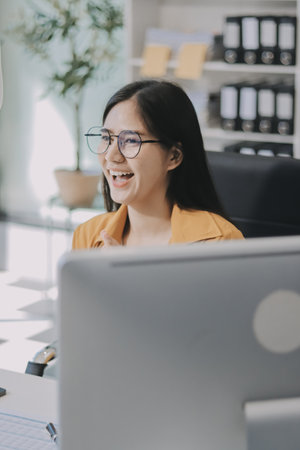 Business woman using calculator for math finance on wooden desk in office and business working background, accounting, statistics and analytic research concept.の写真素材