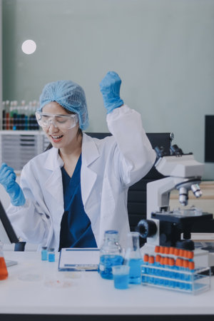 Portrait, science and happy woman on laptop in lab to research chemistry, test or innovation. Microscope, scientist and face of medical doctor in goggles for microbiology, healthcare or pharma studyの写真素材