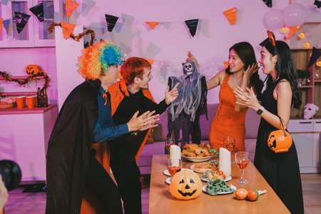 Joyful office Halloween party with coworkers in costumes, celebrating with drinks and laughter,...
