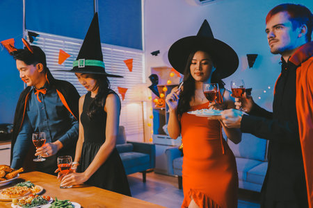 Joyful office Halloween party with coworkers in costumes, celebrating with drinks and laughter, fostering teamwork and festive spiritの写真素材