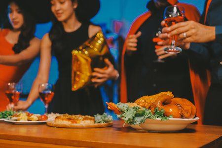 Joyful office Halloween party with coworkers in costumes, celebrating with drinks and laughter,...