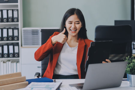 Beautiful young woman working using touchpad tabletの写真素材