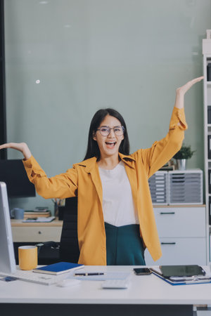 Business woman using calculator for do math finance on wooden desk in office and business working background, tax, accounting, statistics and analytic research concept.の写真素材