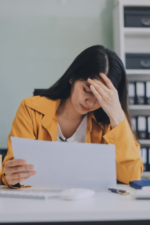 Headache, business woman at night and computer stress while working for a deadline with pc glitch. Sad corporate manager with anxiety about target working at desk screen late to complete task onlineの写真素材