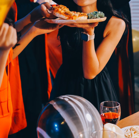 Joyful office Halloween party with coworkers in costumes, celebrating with drinks and laughter, fostering teamwork and festive spiritの写真素材