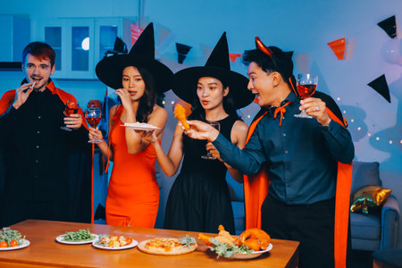 Joyful office Halloween party with coworkers in costumes, celebrating with drinks and laughter, fostering teamwork and festive spiritの写真素材